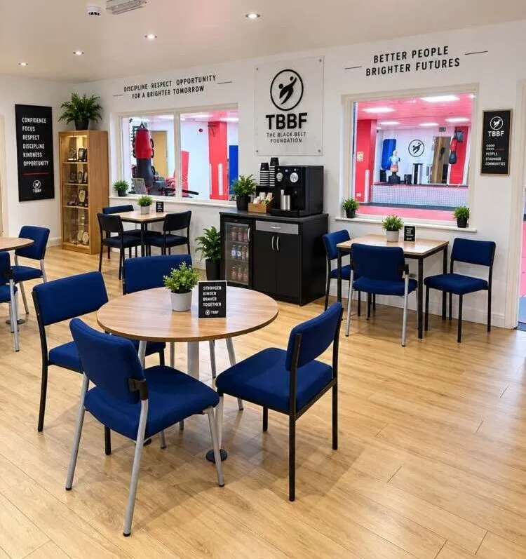 Families relaxing in the cafe seating area at The Black Belt Foundation Chorley